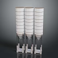 Three Tall White Multi Layered Industrial Storage Silos With Base Supports