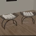 Two Modern Black Metal Frame Stools With White Rolled Towels On Wooden Floor