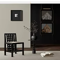 Elegant Portrait Paintings in Black Frames Hanging on Dark Wall With Decorative Chair and Vase