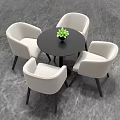 Round Black Table with Four Beige Chairs and Small Green Plant