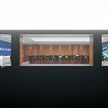 Wooden Paneled Conference Room With Rows of Tables Chairs Green Plants And Ceiling Lighting
