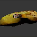 Yellow Banana With Brown Spots On Black Background Showing Reflective Surface
