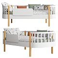 White And Wooden Kids Bed With Safety Railings Decorative Pillows And Patterned Sheets