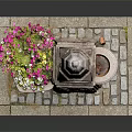 Colorful Potted Flowers Near Stone Tower And Basin On Brick Base Decorative Scene