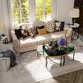 Beige Sofa and Glass Coffee Table Set with Decorative Pillows Gold Frame and Natural Light