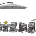 Modern Rattan Outdoor Chairs with White Umbrella Side Table Yellow Flowers and Green Plant