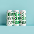 Three Cans of Grapefruit Flavor Beverage with White Cans Green Patterns and Light Blue Background