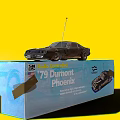 Vintage Electric Toy Remote Control Car 79 Dumont Phoenix on Blue Box with Yellow Background