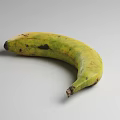 Fresh Ripe Yellow Bananas in Black Wire Basket on Gray Background