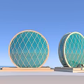 Circular Buildings With Turquoise Diamond Patterned Glass And Light Colored Base Against Blue Sky