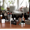 Stylish Perfume and Cosmetics Bottles Neatly Arranged on Wooden Vanity Table with Mirror and Plants