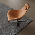 Modern Brown Leather Lounge Chair With Curved Backrest On Gray Woven Rug And Wooden Floor