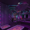 Modern Bar Interior With Neon Lights Purple Tones Laser Lights Bar Counter Seating Area And Stylish Design