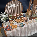 Delicious Dessert And Fruit Platter Display With Floral Decor Wooden Frames Brand Logo At Event