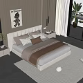 Modern Double Bed with Soft Headboard Plush Pillows Brown Throw Blanket and Light Carpet