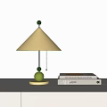 Minimalist Table Lamp With Beige Cone Shade And Green Decorative Balls Beside Stacked Books