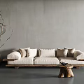 Beige Three Seater Sofa With Wooden Base Plush Pillows And Small Wooden Coffee Table