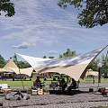 Scenic Park Landscape With Lush Trees Green Grass Camping Tents Playground And Seating Area