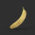 Ripe Yellow Banana With Brown Spots Isolated On Dark Background