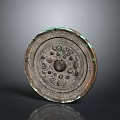 Ancient Bronze Circular Sculpture With Intricate Carved Patterns And Central Motif