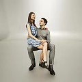 Couple Sitting Together In Minimalist Gray Background With Blue Floral Dress And Gray Outfit