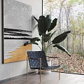 Modern Interior Decor With Abstract Painting Black Chair Large Green Plant White Planter And Window