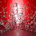 Red Garden Ornament Vase With Splashing Water On Red Background