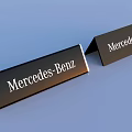 Three Black Mercedes Benz Branded Signs With White Lettering And Unique Shapes