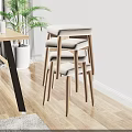 Stacked Stools With Beige Padded Seats And Wooden Legs On Light Wood Floor
