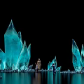 Illuminated Blue Ice Crystal Art Installation On Black Background With Water Reflection And People Nearby