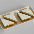 Delicious Three Triangular Layered Cream Sponge Cakes on Light Tray