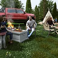 Garden Landscape With Lush Grass Wooden Deck Campfire Area Trees Rock And Parked Vehicles