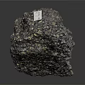 Natural Black Wood Stone With Golden Spots And Label On Dark Background