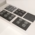 Various Modern Kitchen Appliances Including Gas And Electric Cooktops On White Counter