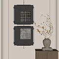 Black Framed Wall Art With Vase And Twigs On Small Cabinet With Books