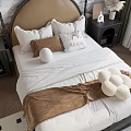 Elegant Double Bed With Brown Headboard White Sheets Decorative Pillows And Soft Blanket