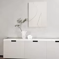White Ceramic Vase With Green Branches And Smaller Vase On Light Wall With Geometric Painting