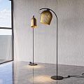 Two Modern Floor Lamps With Golden Shades And Black Stands In Bright Interior