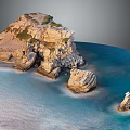 Rocky Coastal Terrain With Blue Water Scattered Rock Formations And Greenery