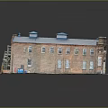 Red Brick Residential Building With Blue Roof Multiple Windows And Green Ground Area