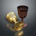 Shiny Gold And Brown Metal Cups One Tilted One Standing On Dark Background
