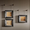 Three Black Framed Oil Paintings With Landscape Scenes Hanging On Gray Wall