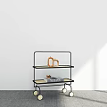 Three Tier Rolling Cart With Black Frame Ceramic Vase And Book On Gray Floor