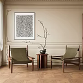 Two Green Cushioned Wooden Frame Lounge Chairs With Small Round Table And Beige Wall Art