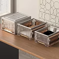 Three Transparent Storage Boxes with Gold Frame for Desk Organization on Wooden Table