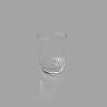 Clear Glass Cup With Vertical Stripes And Decorative Base On Simple Gray Background