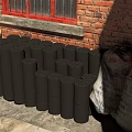 Black Cylindrical Blocks Stacked By Red Brick Wall With Bamboo Chair And Sacks