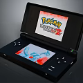 Black Handheld Game Console With Dual Screens Showing Pokémon White 2