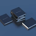 Black Cover Book of Art Books Stacked and Laid Flat on Blue Surface