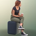 Woman Sitting On Dark Cube Holding Coffee Cup In Black T-Shirt Green Pants White Sneakers